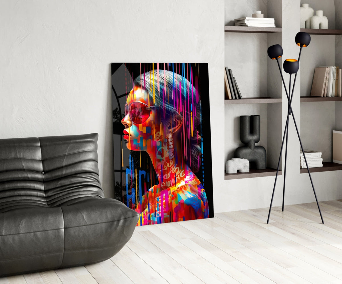 Rainbow drip woman in profile glass wall art leaning beside a black leather lounge chair and shelves