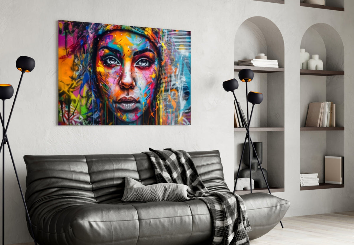 Graffiti woman glass wall art above a black leather sofa with arched shelves