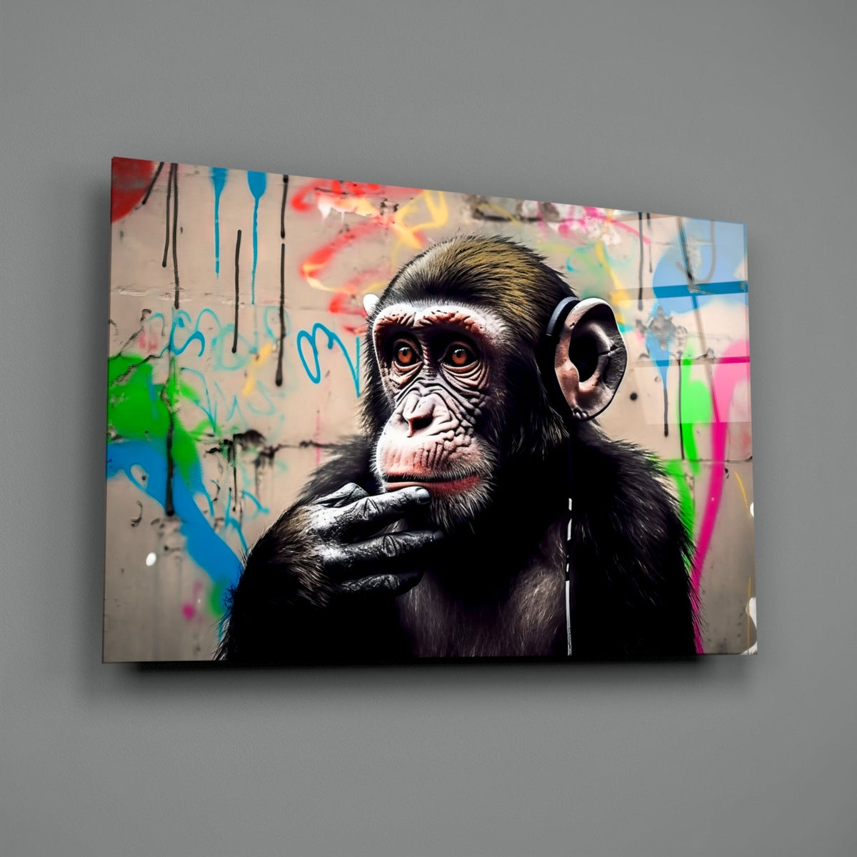 Thinking chimpanzee with headphones glass wall art on a plain gray wall