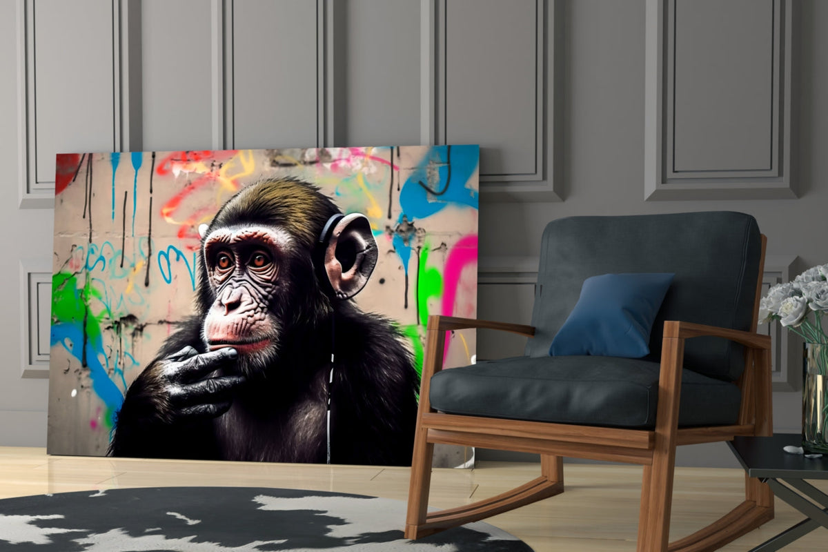 Thinking chimpanzee with headphones glass wall art leaning behind a blue armchair on a cowhide rug