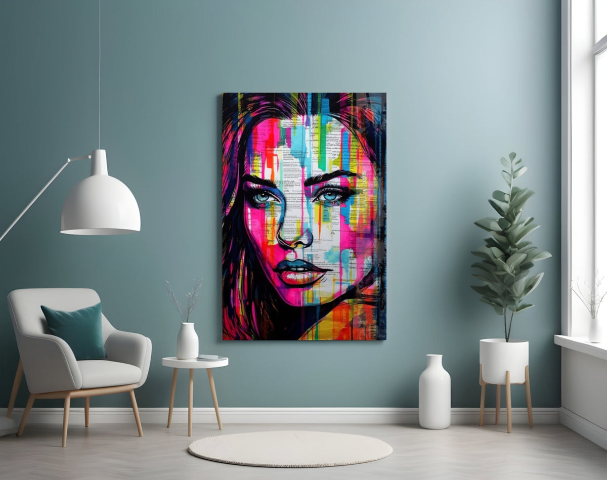 Newsprint drip woman glass wall art on a pale blue wall above a white armchair and a potted tree