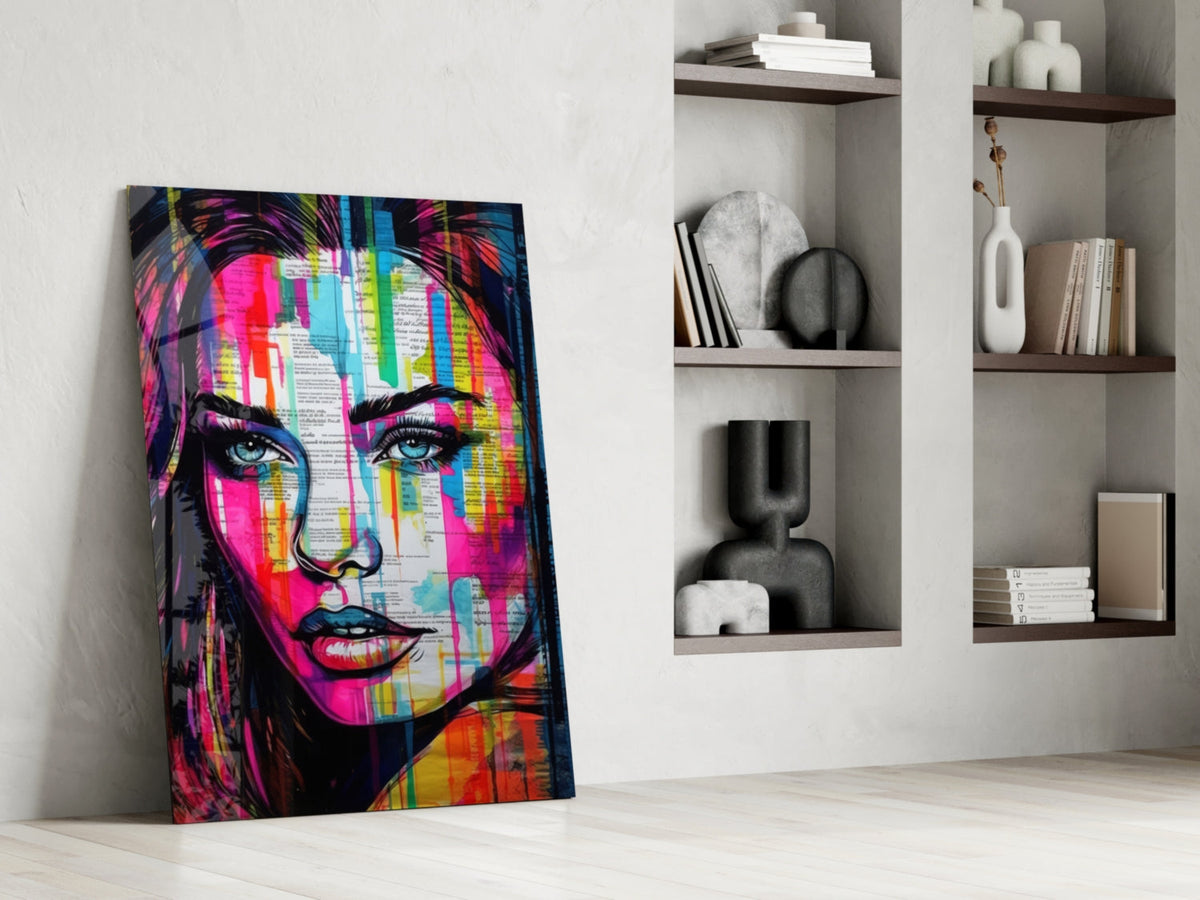 Newsprint drip woman glass wall art leaning on the floor beside open shelves with vases