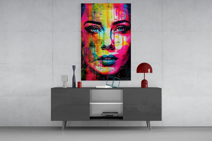 Neon drip portrait woman glass wall art above a gray sideboard with a small table lamp on a white wall