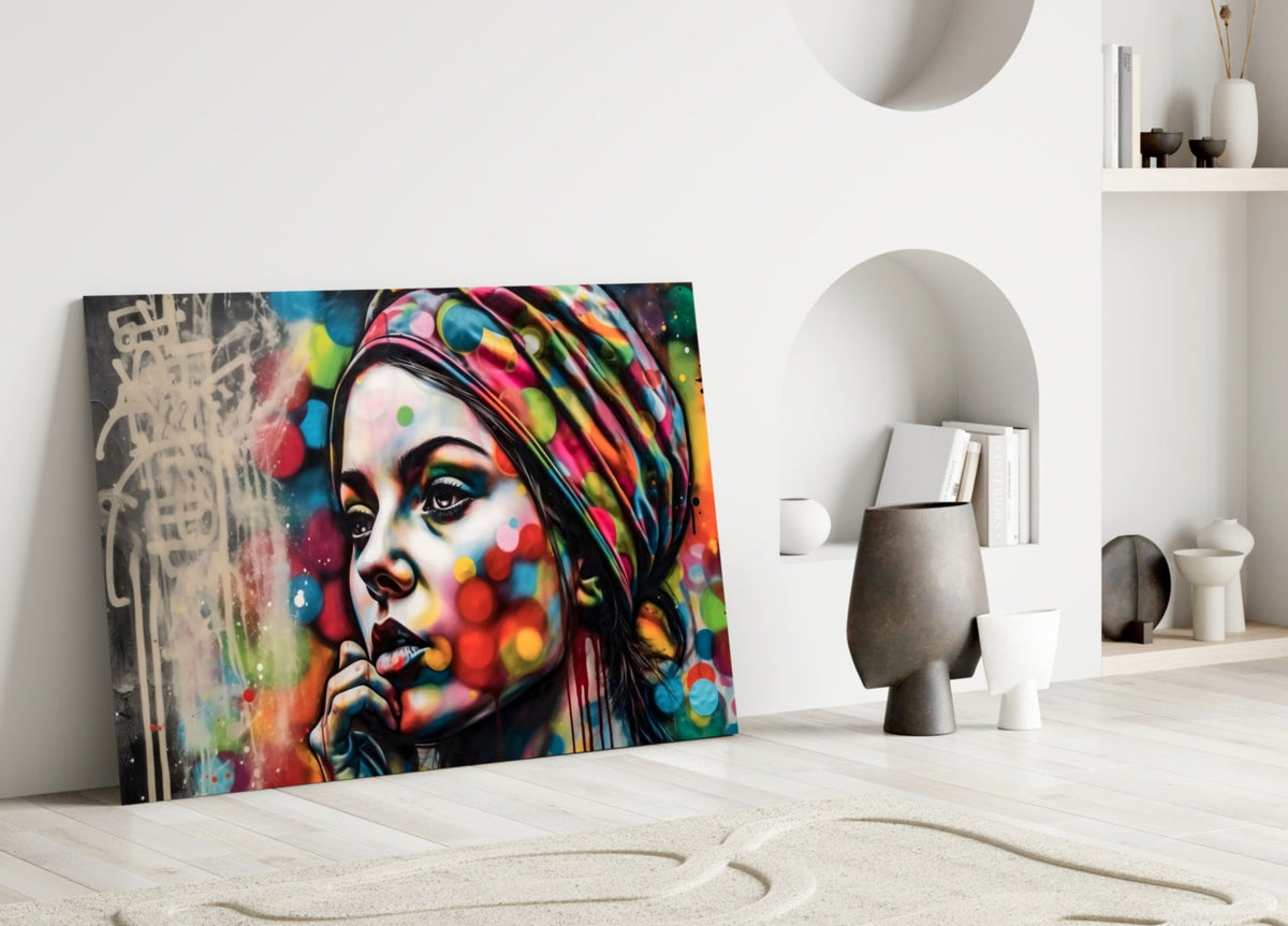 Woman in a polka dot turban glass wall art leaning against a white wall beside an arched alcove