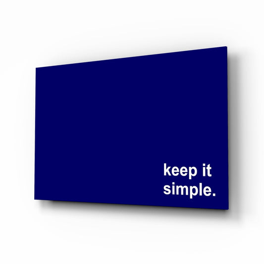 Keep it simple white text on navy glass wall art on a white background, shown at a slight angle
