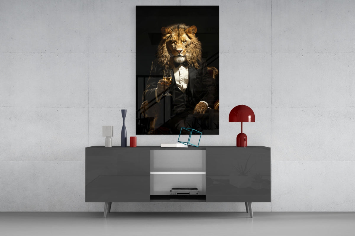 Tuxedo lion glass wall art above a gray sideboard with a red table lamp
