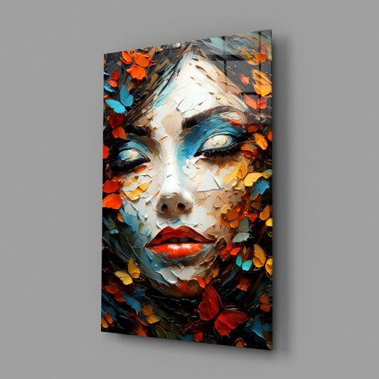 Butterfly and petal woman face glass wall art hanging on a gray wall