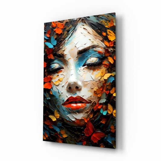 Woman face surrounded by orange and blue butterflies and petals, glass wall art on a white background