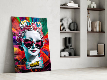 White bust in sunglasses glass wall art leaning against a white wall beside open shelves