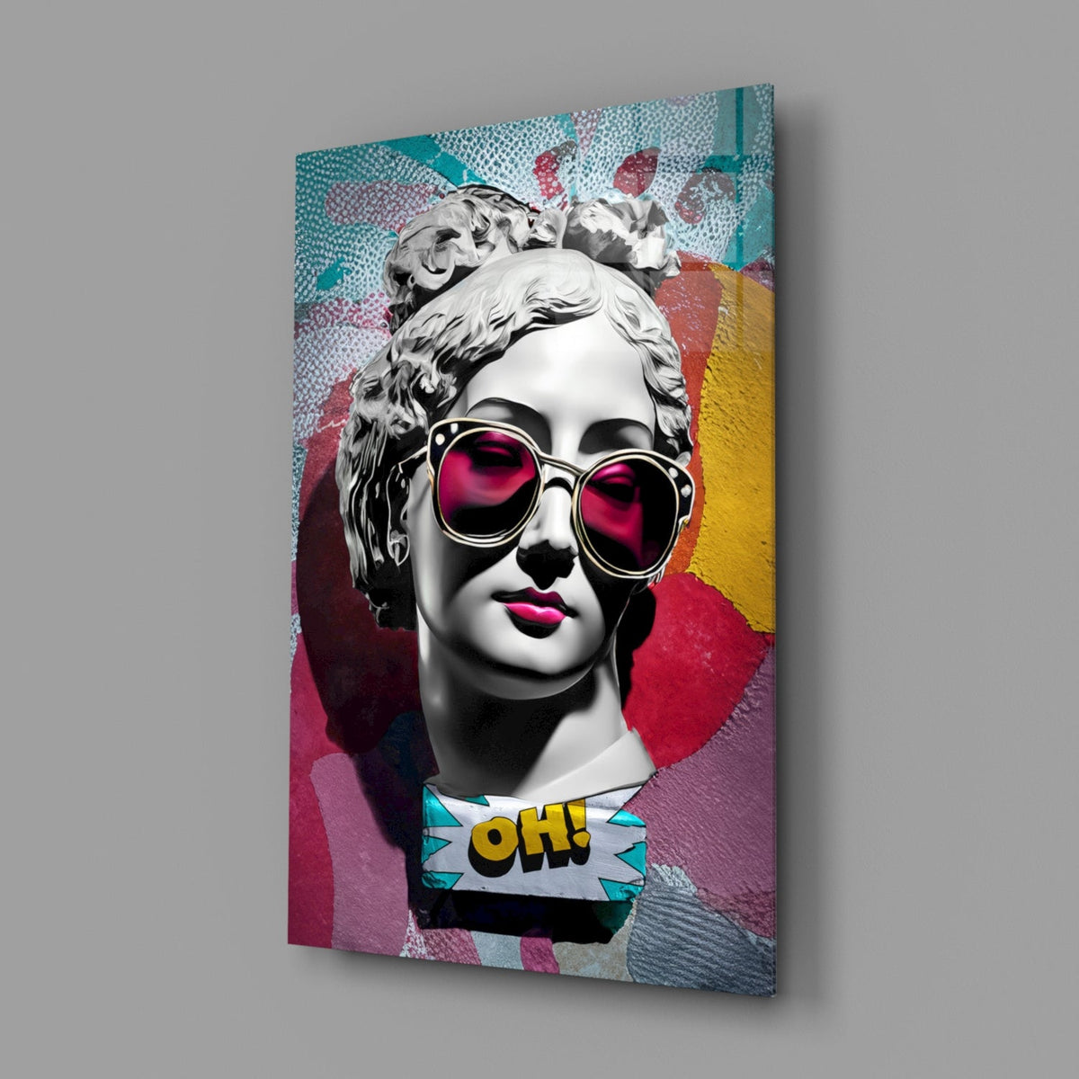 Marble bust in pink sunglasses on teal collage glass wall art angled against a soft gray backdrop