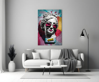 Marble bust in pink sunglasses on teal collage glass wall art above a white sofa and coffee table beside a black floor lamp