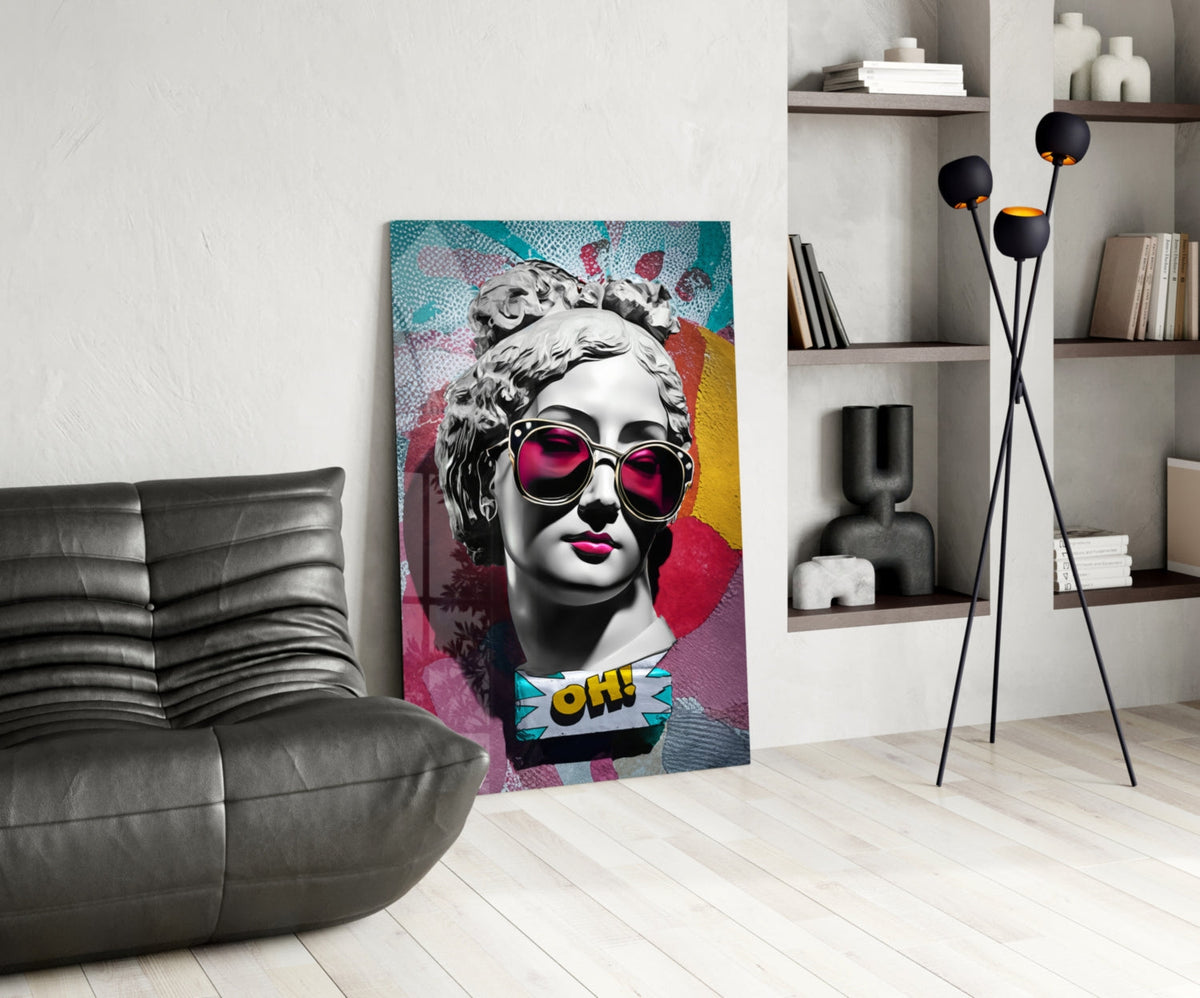 Marble bust in pink sunglasses on teal collage glass wall art leaning beside a black leather lounge chair and open shelves