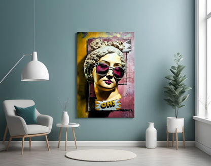 Gold bust in sunglasses on torn pink wall glass wall art on a blue-gray wall above a white armchair and a pendant lamp