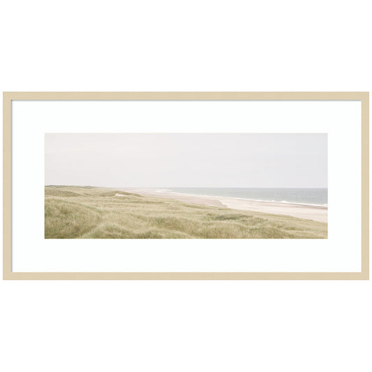 Peaceful coastal shoreline with soft open water in a wood frame