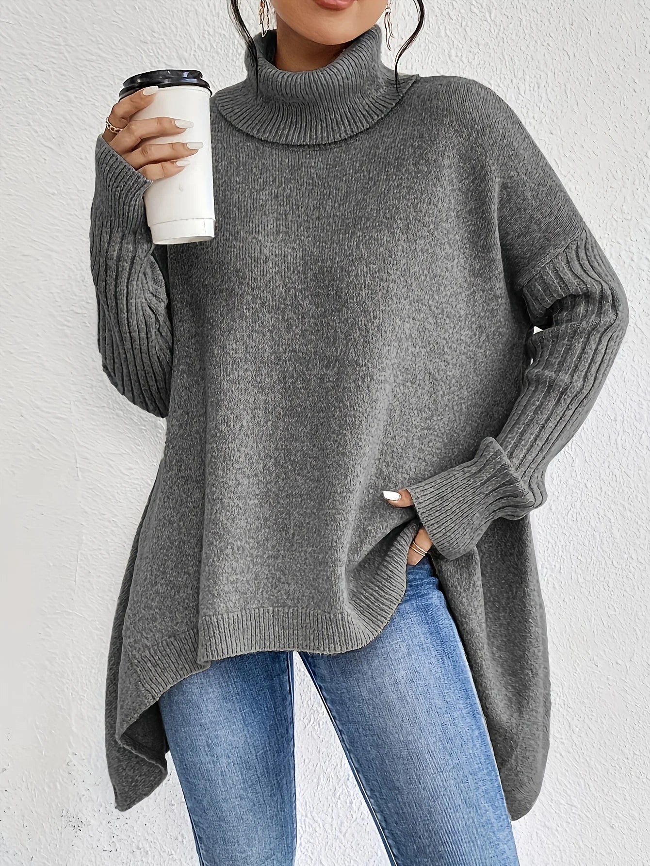 grey asymmetric hem sweater worn with jeans
