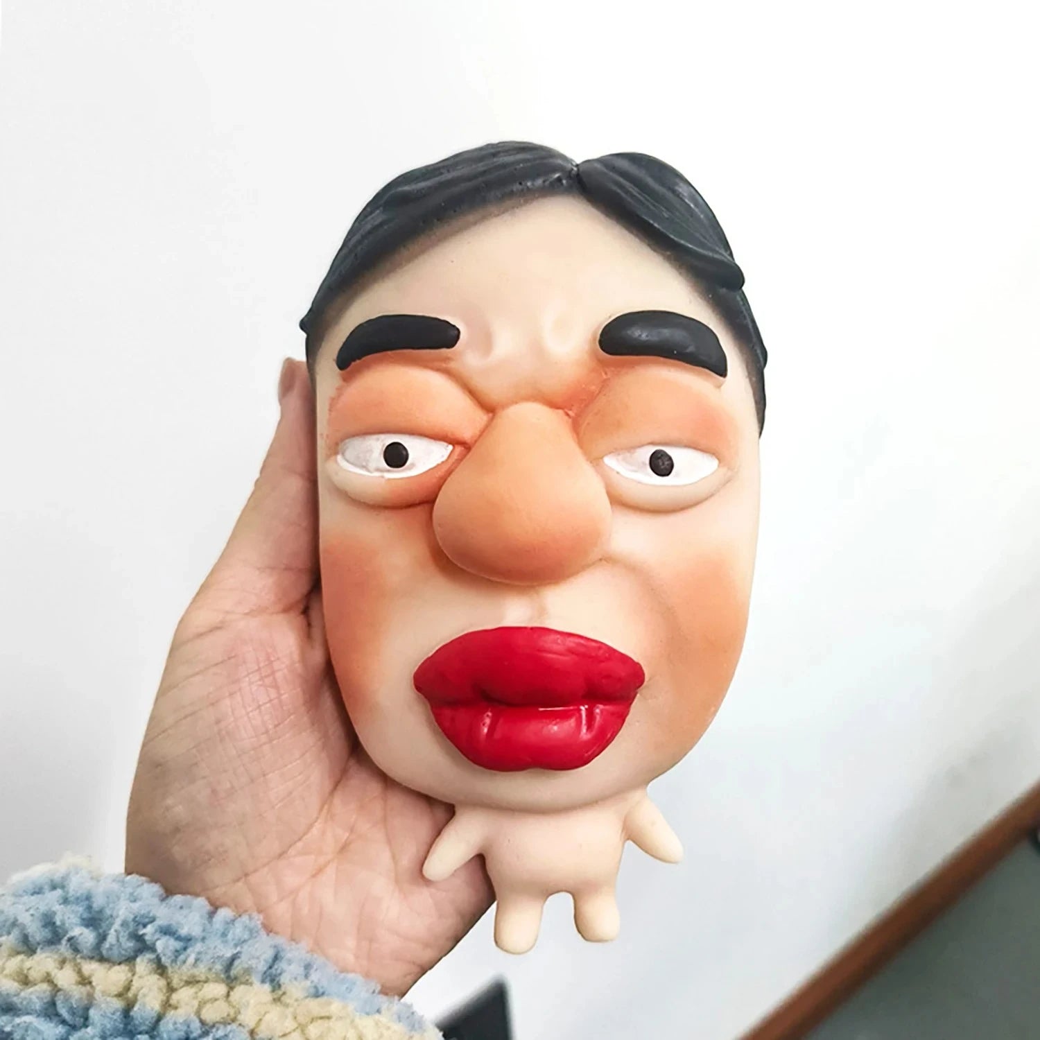 hand squishing silicone face stress toy big red lips