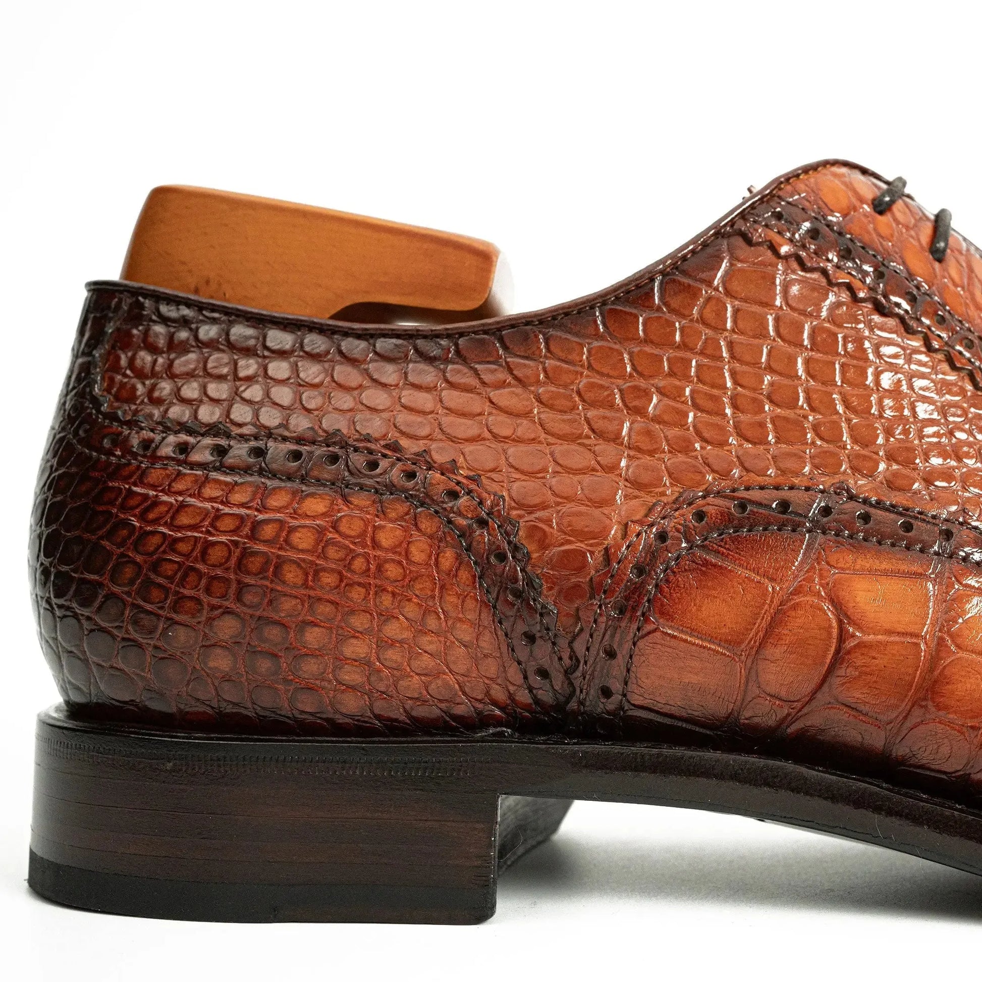 heel and welt close up on brown alligator dress shoe