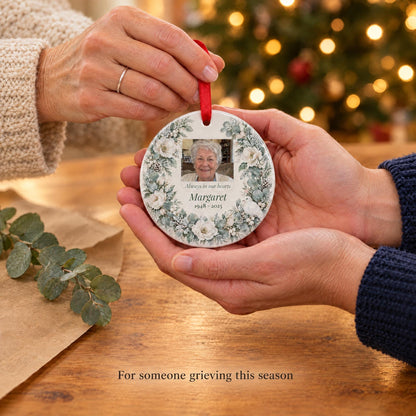 A friend gently giving a personalized memorial photo ornament, a sympathy gift for someone grieving at Christmas