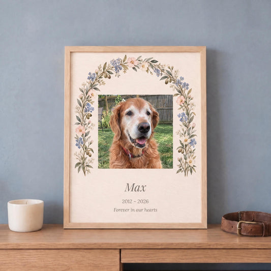 Pet memorial gift: custom dog photo print with name and years in a light wood frame, leaning on a dresser by a collar