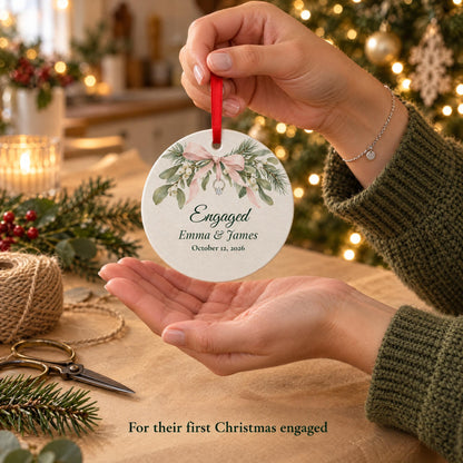 A friend holding a first Christmas engaged ornament over kraft paper, a gift for the newly engaged couple