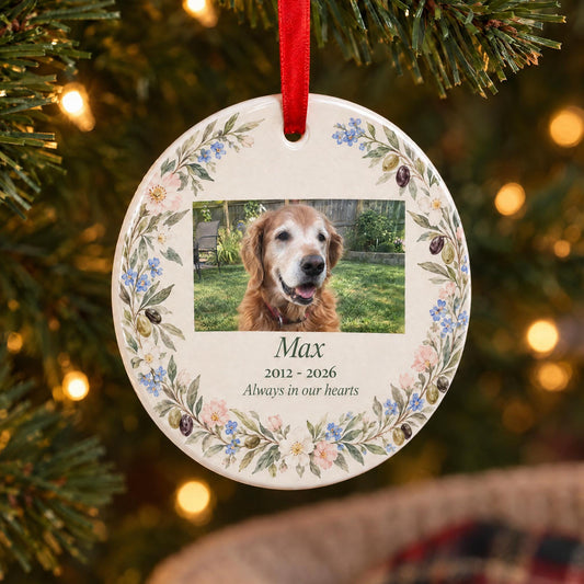 Pet memorial ornament with photo of a dog in a watercolor wildflower wreath, on a Christmas tree above a pet bed