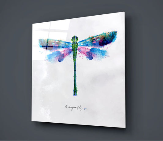 Blue watercolor dragonfly glass wall art on a dark gray wall