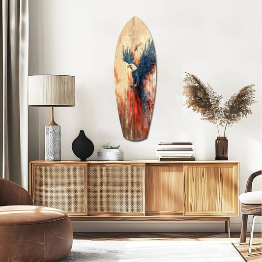 Blue winged eagle surfboard glass wall art above a rattan sideboard with a table lamp and pampas grass