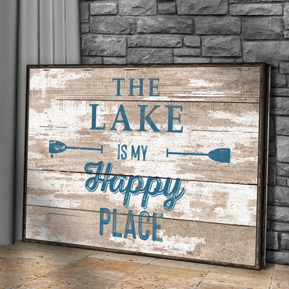 Lake Is My Happy Place canvas leaning against a gray stone wall, angled view