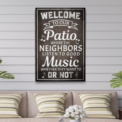 Tall welcome patio canvas sign with white chalk-style lettering and music notes on a dark gray look, hung on white siding