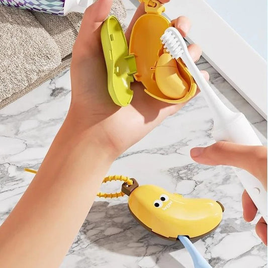 Hand holding a banana-shaped toothbrush holder with a toothbrush inside on a marble surface.