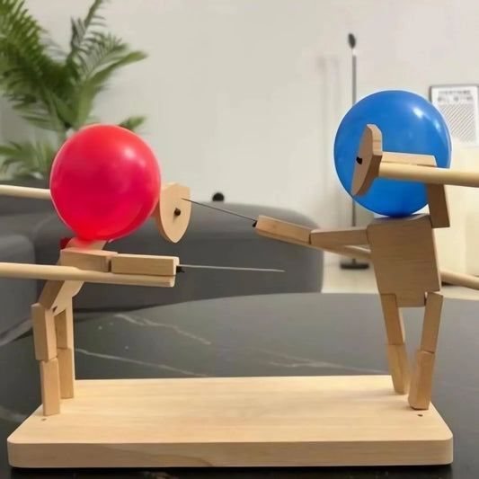 Wooden toy figure with red and blue balloons on a reflective surface