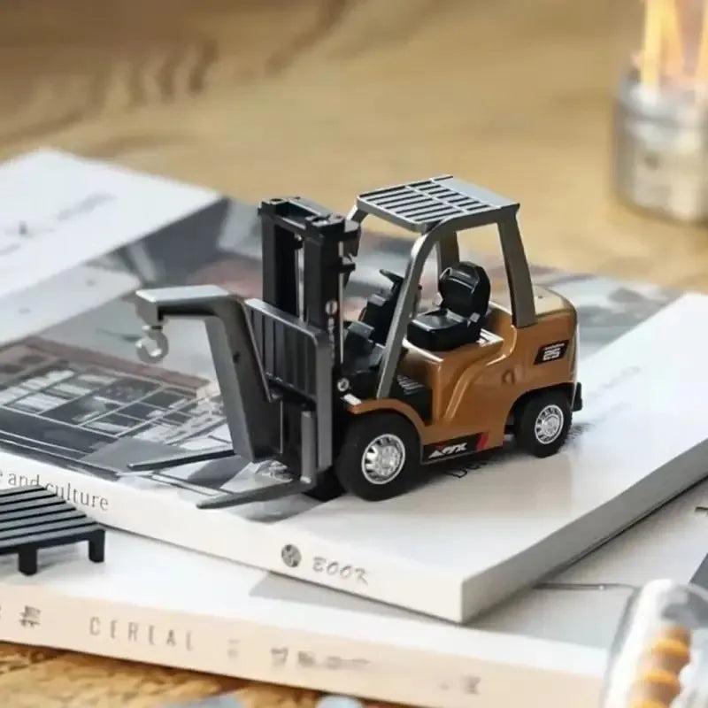 Toy forklift on top of a book with a blurred background