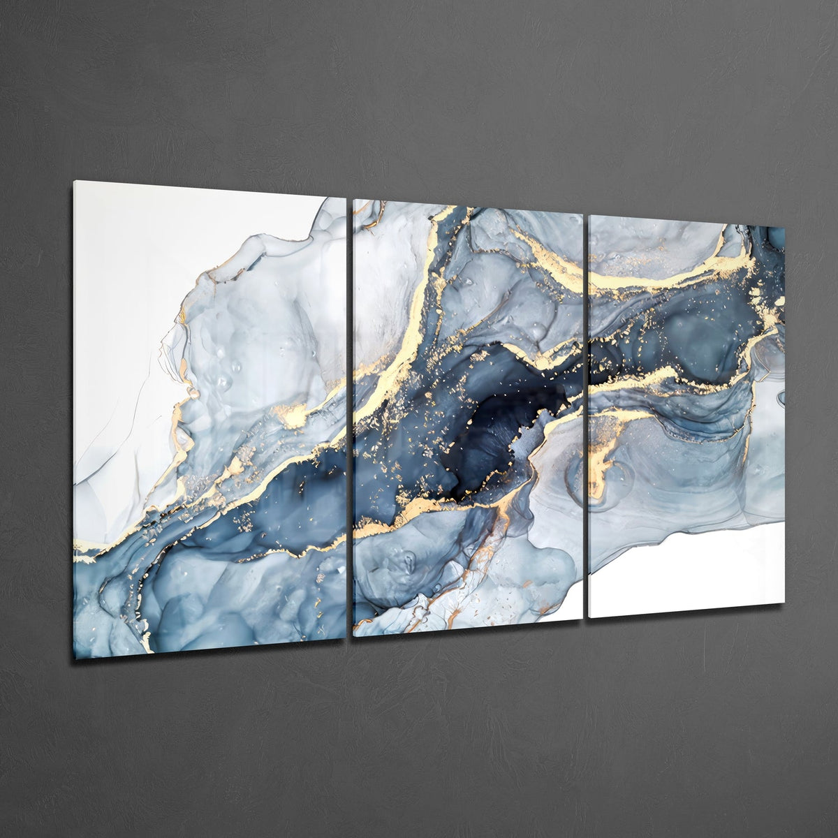 Blue and gold marble ink 3-panel glass wall art on a gray wall, light reflecting off the glossy fronts
