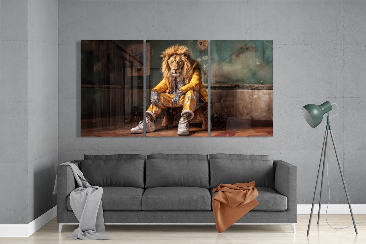 Lion in a yellow puffer jacket 3-panel glass wall art set above a gray sofa beside a floor lamp