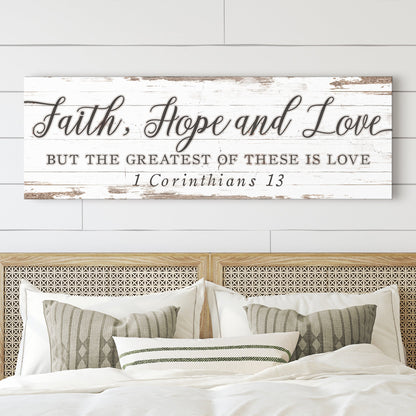 Long white distressed canvas sign, Faith, Hope and Love, but the greatest of these is love, 1 Corinthians 13, above a bed