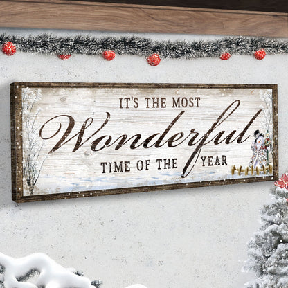 Wonderful Time of the Year Snowman canvas in an angled close-up on a white wall under red-bauble tinsel