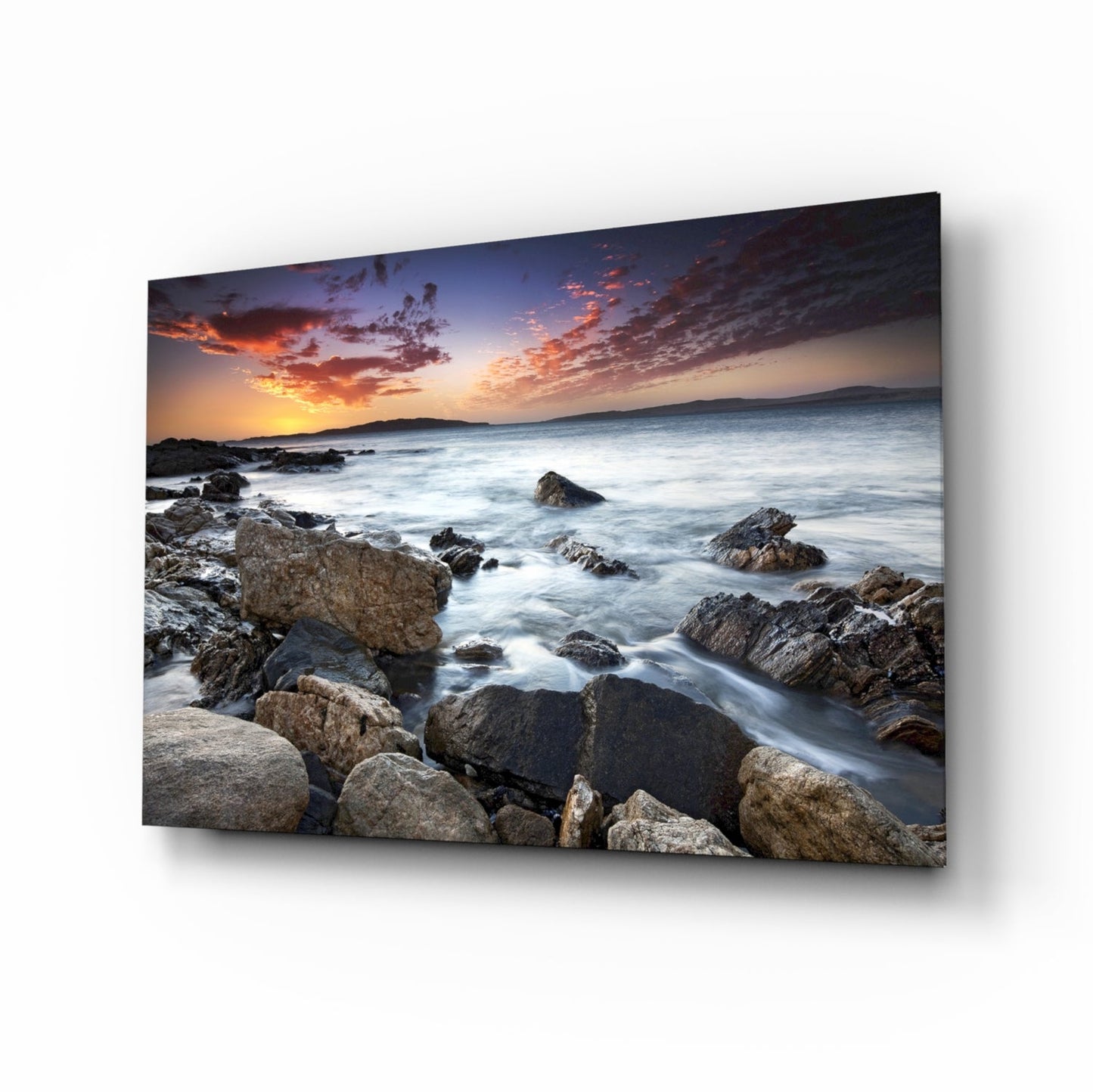 Rocky shore sunset seascape glass wall art with silky waves