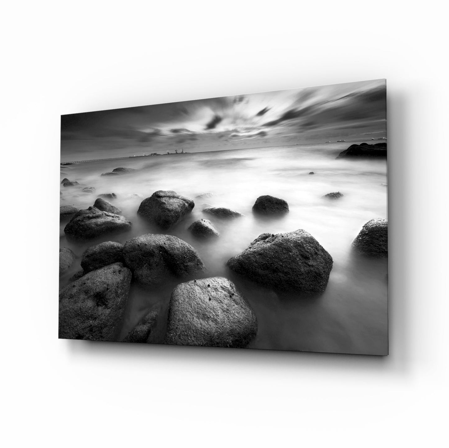 Black and white misty sea boulders glass wall art