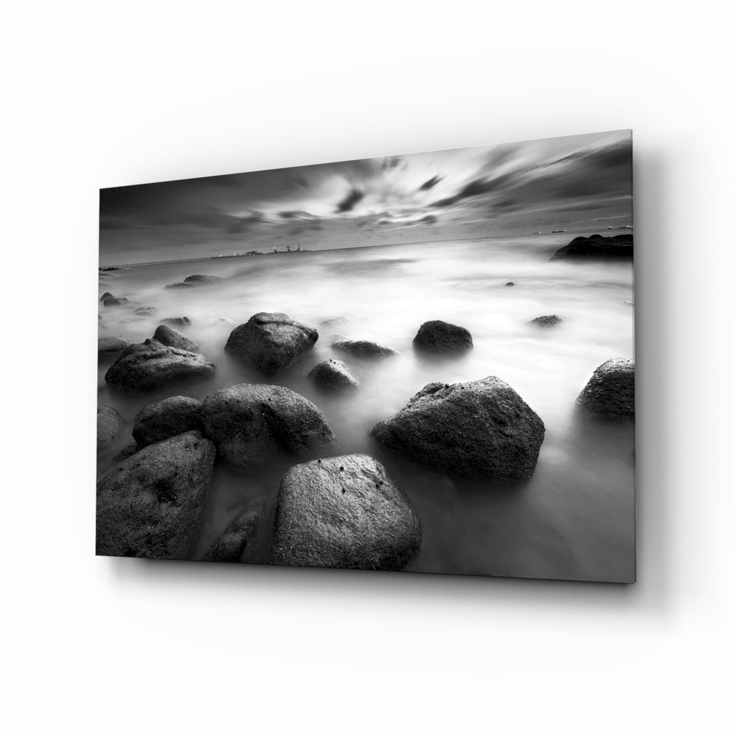 Black and white misty sea boulders glass wall art