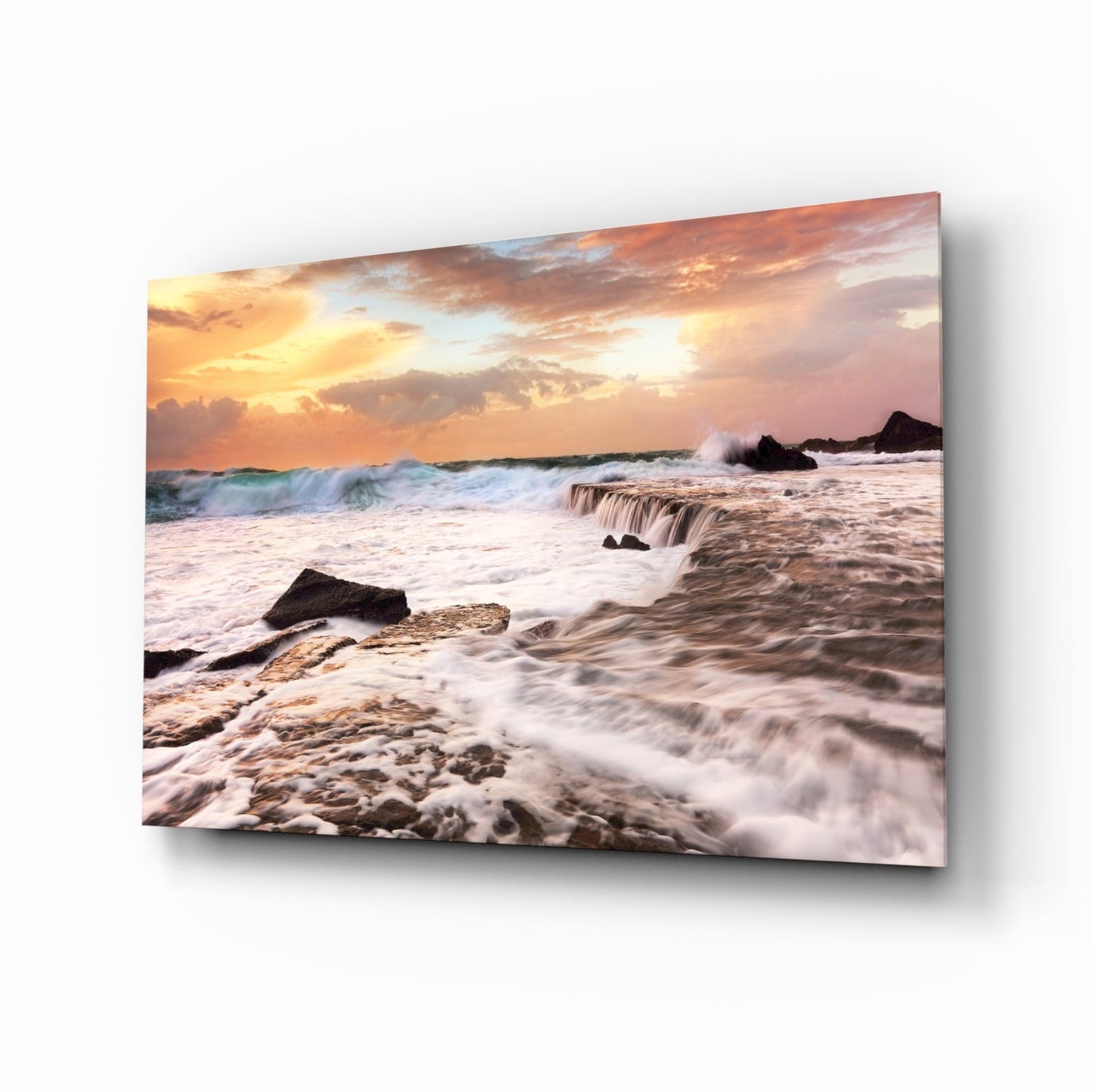 Vicious waves glass wall art, white surf crashing over coastal rocks at peach-coral golden hour