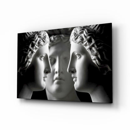 Black and white mirrored statue faces glass wall art