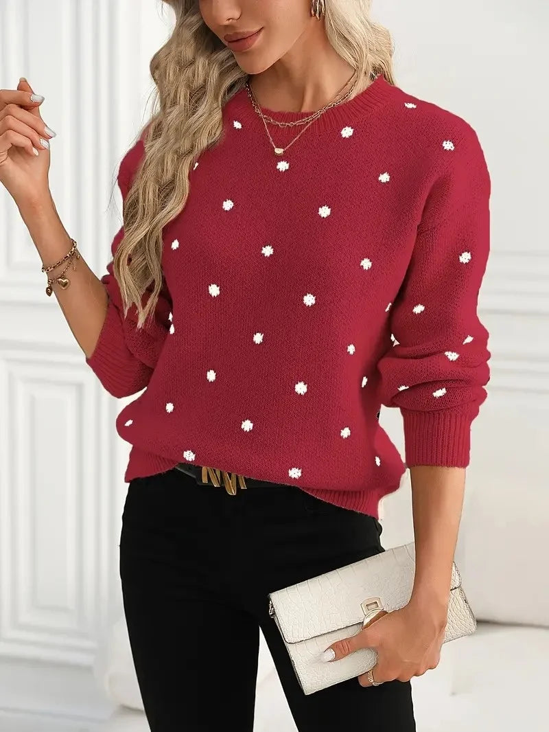 rich wine-red sweater with white polka dots, styled with black trousers and layered gold jewelry