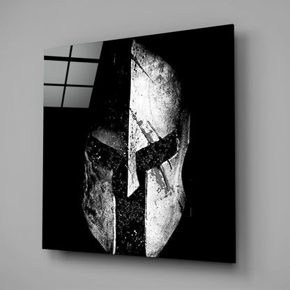 Black and white Spartan helmet square glass wall art on a gray wall with a window reflection