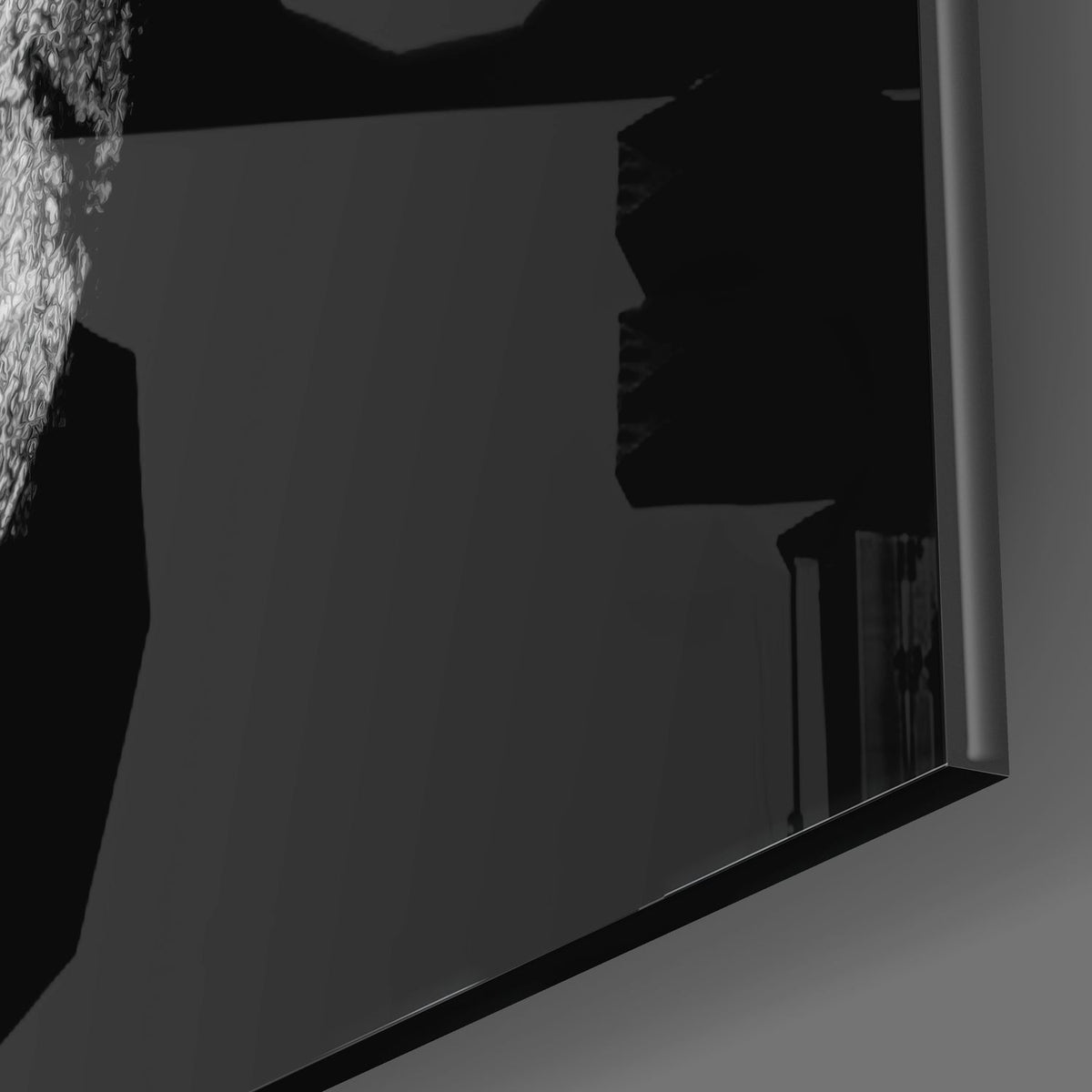 Close-up of the glossy tempered glass edge of the black and white Spartan helmet piece