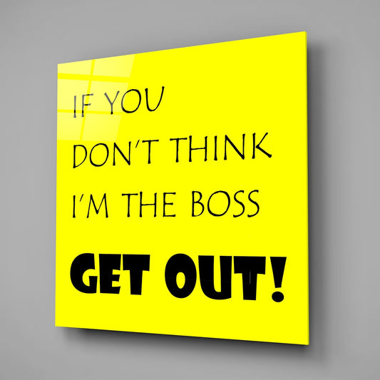 Funny boss quote in black text on yellow square glass wall art on a gray wall with a soft shadow
