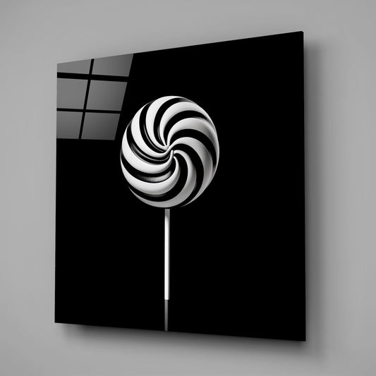 Swirl lollipop glass wall art on a gray background with a window reflection on the black glass