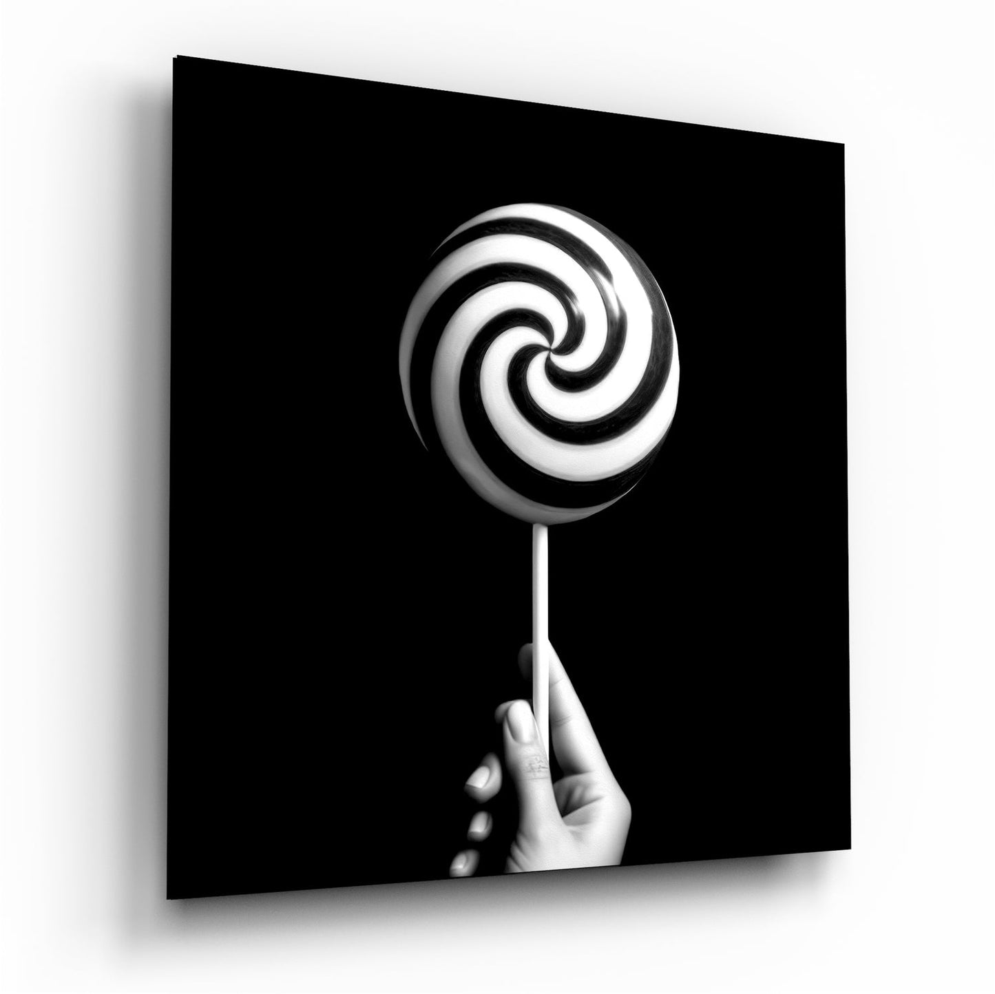 Hand holding spiral lollipop glass wall art