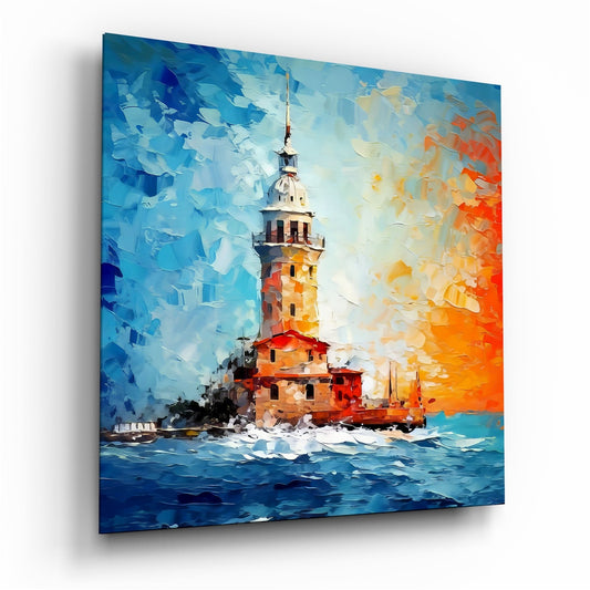 Small tower on a rocky islet in a choppy blue sea under an orange and blue sky, glass wall art on a white background