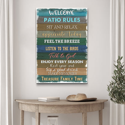 Patio Rules Teal Plank canvas sign hung above a wooden console table with a straw hat