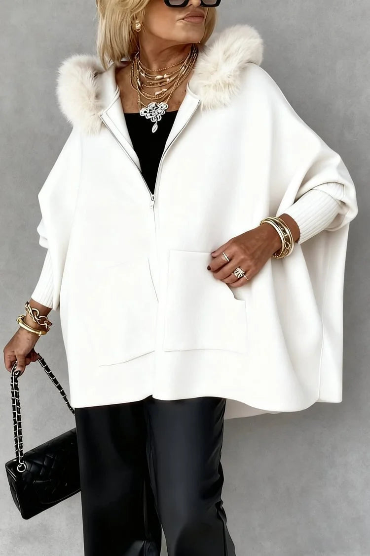 white faux fur hooded zip cape worn by woman

